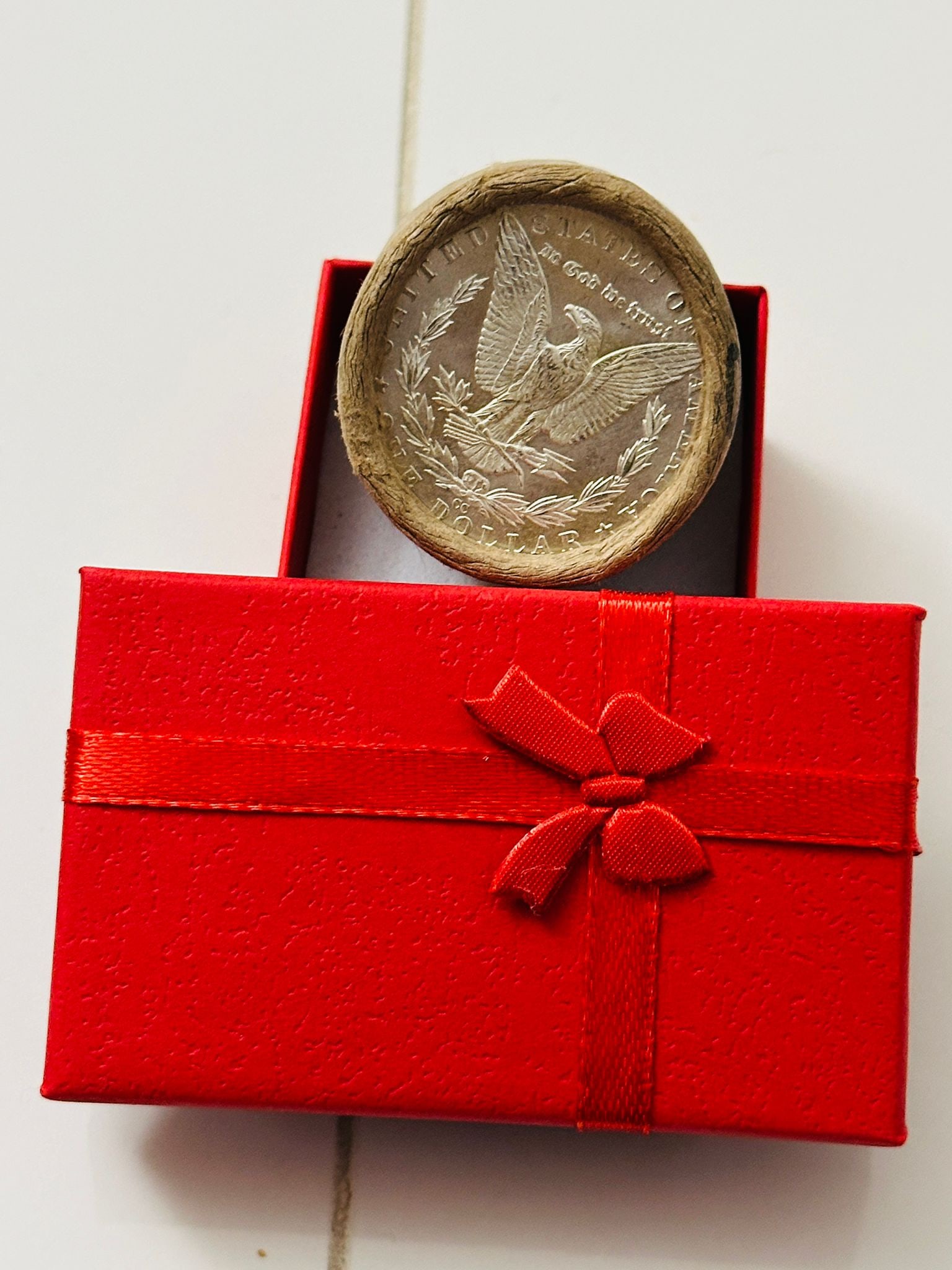 BU $20 Morgan Silver Dollar Roll of ALL CC's: An original Brilliant Uncirculated (BU) sealed roll containing 20 Morgan Silver Dollars, all minted at the historic Carson City (CC) Mint. The roll remains sealed with only the end coins visible; howe
