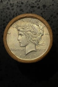 BU $10 Peace Silver Dollar Roll 1928 & S Ends: An original Brilliant Uncirculated (BU) sealed roll containing 10 Peace Silver Dollars, featuring a 1928 coin on one end and a San Francisco (S) Mint coin on the other. The roll remains sealed to ensu