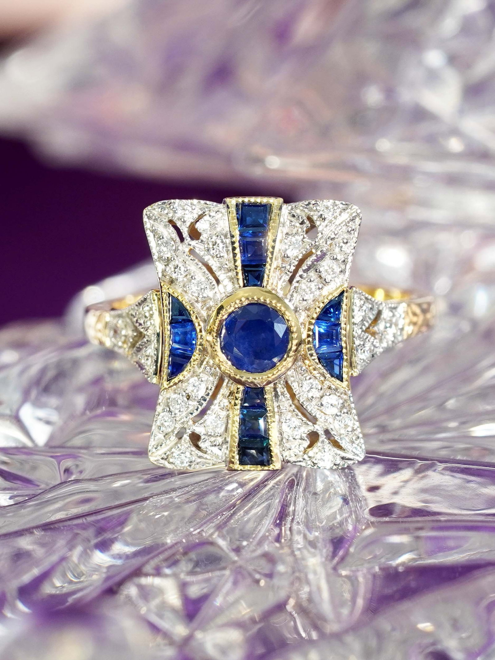 9K Yellow Gold Sapphire and Diamond Art Deco Style Engagement Ring: Ring Information Style: Art-deco Metal: 9K Yellow Gold Total weight: 3.83 g. (approx. total weight) Size: US7 Center Gemstones Type: Blue Sapphire Shape: Round Size: 4 mm. Number: 1 Weight: 0.3