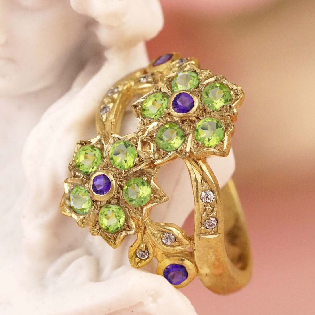 9K Yellow Gold Natural Amethyst Peridot and Diamond Vintage Style Floral Cluster Ring: CHARACTERISTICSOrigin: ThailandMetal: Solid 9K Yellow GoldRing Size: US 7Total Gemstones Weight: 0.61 carat. (approx.)Total Gram Weight: 5.10 g. (approx.)*Pictures have been enlarged to show details*P
