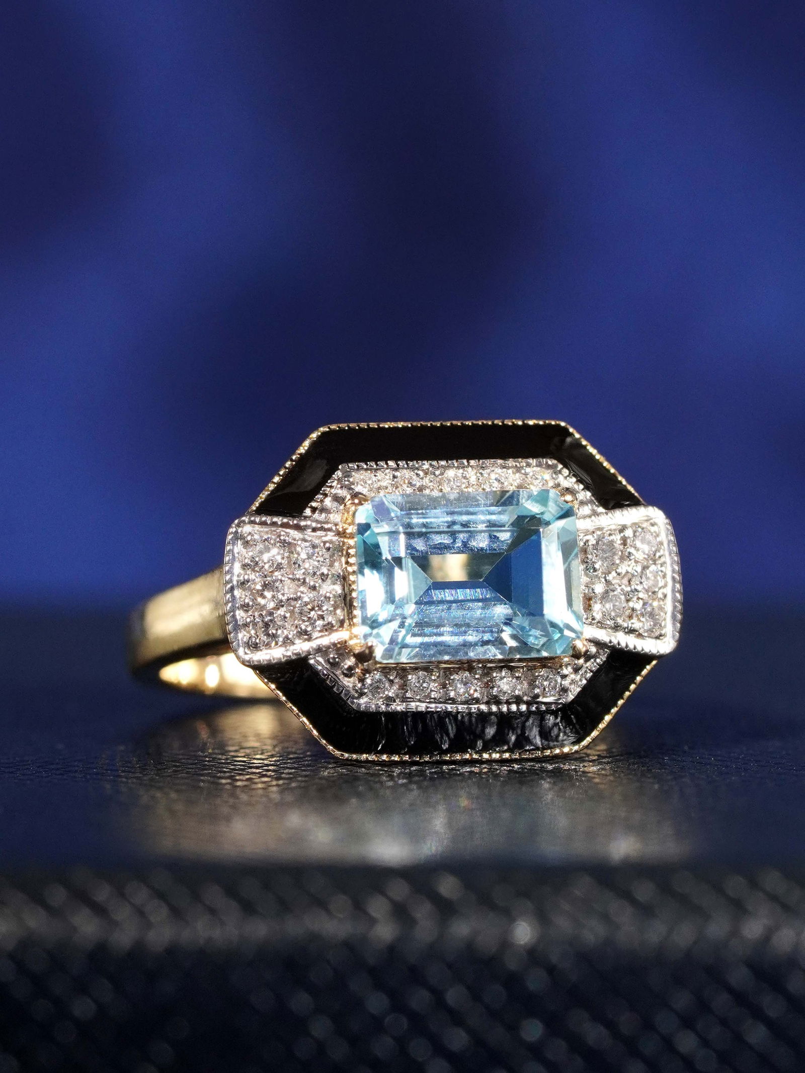 14K Yellow Gold Natural Aquamarine Diamond and Black Enamel Art Deco Style Ring: Ring InformationStyle: Art-decoMetal: 14K Yellow GoldWeight: 4.39 g. (approx. total weight)Size: US 7Center Gemstones Type: AquamarineShape: Emerald CutSize: 8 x 6 mm.Number: 1Weight: