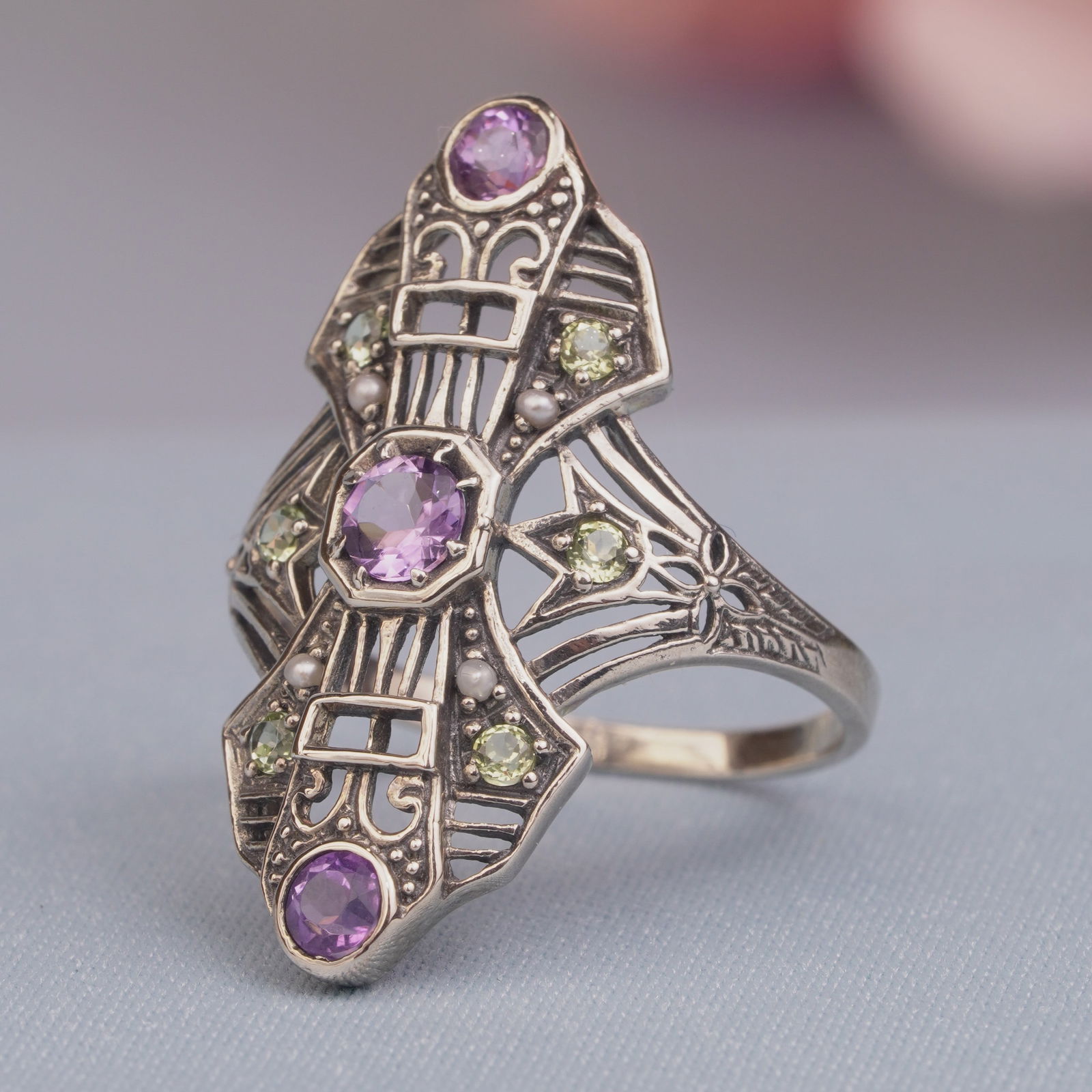 Silver925 Natural Amethyst Peridot Pearl Vintage Filigree Ring: CHARACTERISTICSStatus: In stockOrigin: ThailandMetal: Silver 925Ring Size: US 6Total Gemstones Weight: 0.67 carat. (approx.)Total Gram Weight: 2.52 g. (approx.)*Pictures have been enlarged to show det