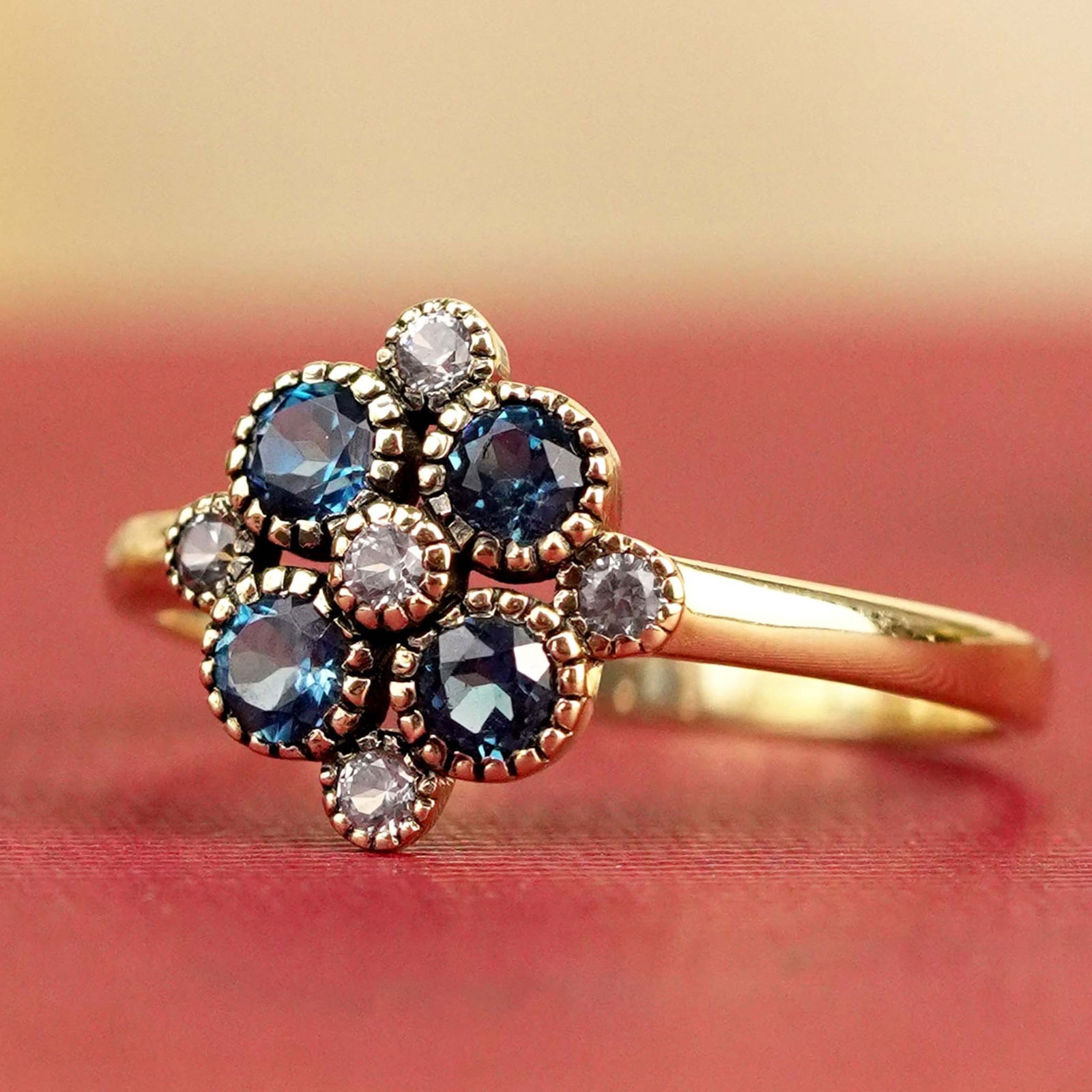 9K Yellow Gold Natural Blue Topaz and Sapphire Vintage Style Floral Ring: CHARACTERISTICSOrigin: ThailandMetal: Solid 9K Yellow GoldRing Size: US 7Total Gemstones Weight: 0.76 carat. (approx.)Total Gram Weight: 1.59 g. (approx.)*Pictures have been enlarged to show details*P