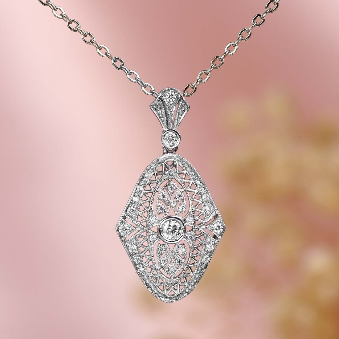 14K White Gold Natural Diamond Vintage Style Filigree Pendant: CHARACTERISTICSOrigin: ThailandMetal: 14K White GoldPendant Size: 16 mm. (w) x 32 mm. (l) *this pendant is supplied without a chain*Total Gemstones Weight: 0.33 carat (approx.)Total Gram Weight: 2.44