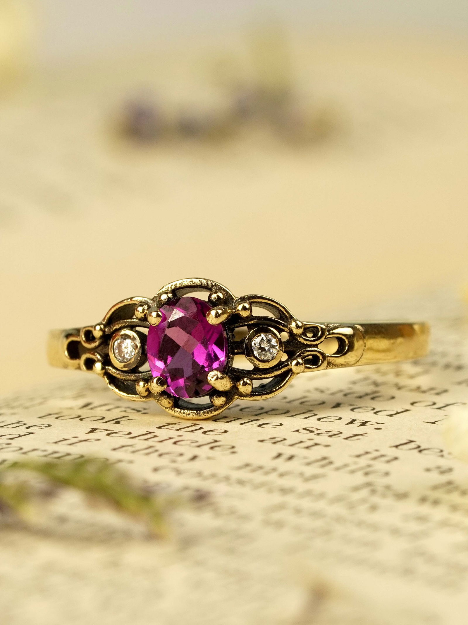 9K Yellow Gold Natural Rhodolite and Diamond Vintage Style Engagement Ring: CHARACTERISTICSOrigin: ThailandMetal: Solid 9K Yellow GoldRing Size: US 7Total Gemstones Weight: 0.47 carat. (approx.)Total Gram Weight: 1.47 g. (approx.)*Pictures have been enlarged to show details*P