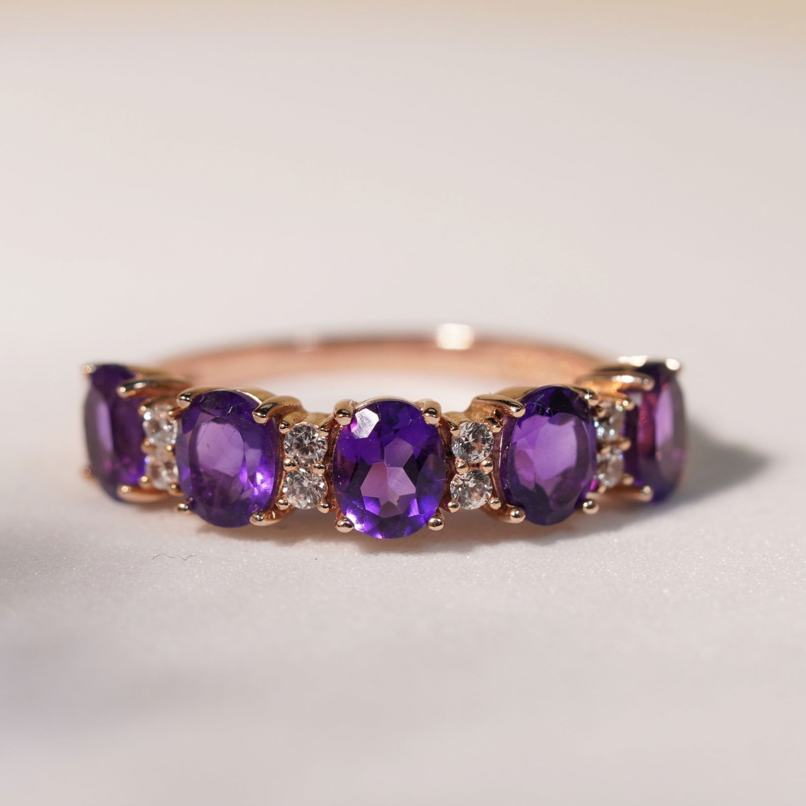 18K Rose Gold Plate Sterling Silver Natural Amethyst White Zircon Half Eternity Ring: 18K Rose Gold Plate Sterling Silver Natural Amethyst White Zircon Half Eternity Ring Stone: Natural Amethyst, White Zircon Metal: Gold plated silver 925 Approx. Weight: 2.23 g. Approx. Gemstone Weight
