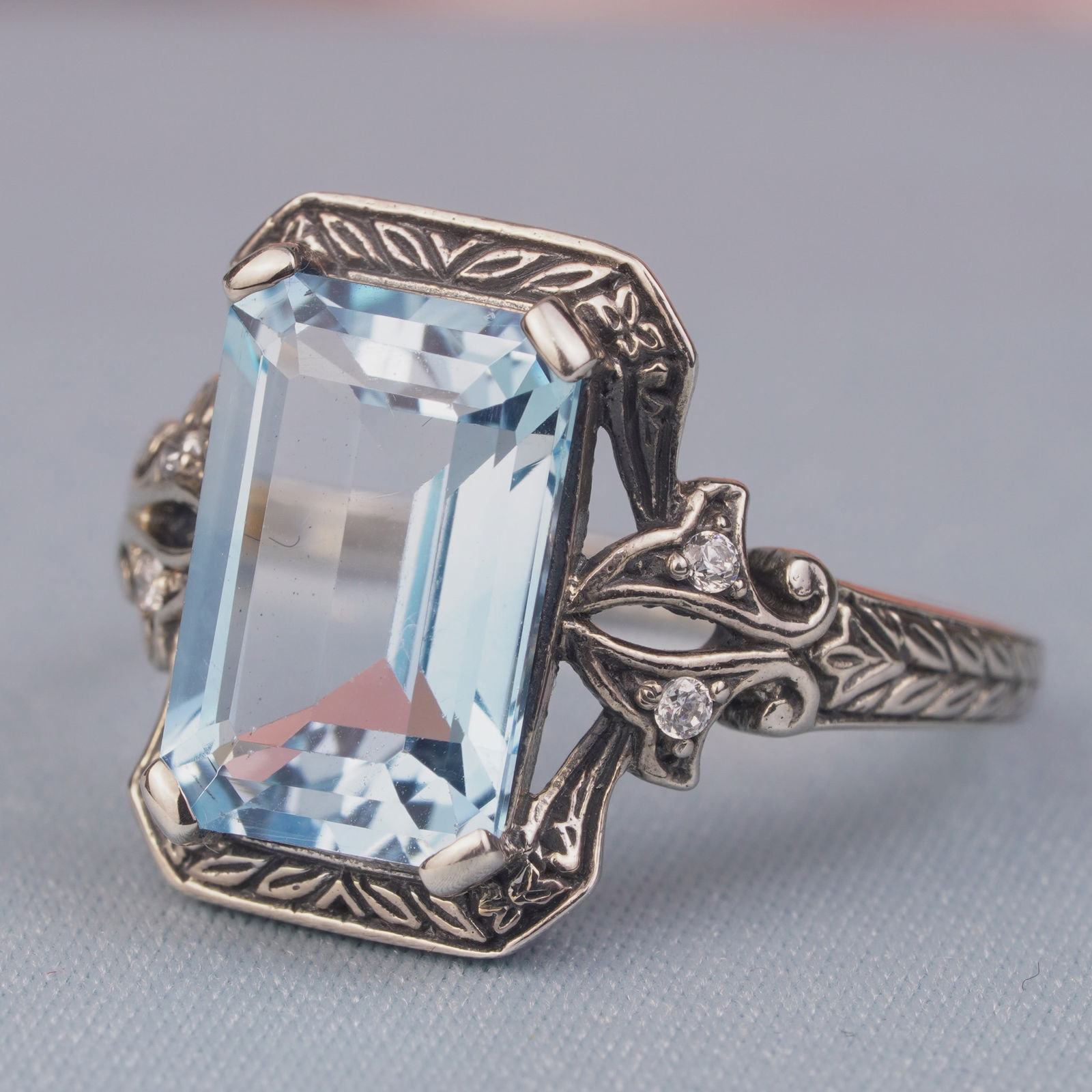 Silver925 Blue Topaz Cubic Zirconia Vintage Filigree Ring: CHARACTERISTICSStatus: In stockOrigin: ThailandMetal: Silver 925Ring Size: US 7.25Total Gemstones Weight: 4.62 carat. (approx.)Total Gram Weight: 3.7 g. (approx.)*Pictures have been enlarged to show d