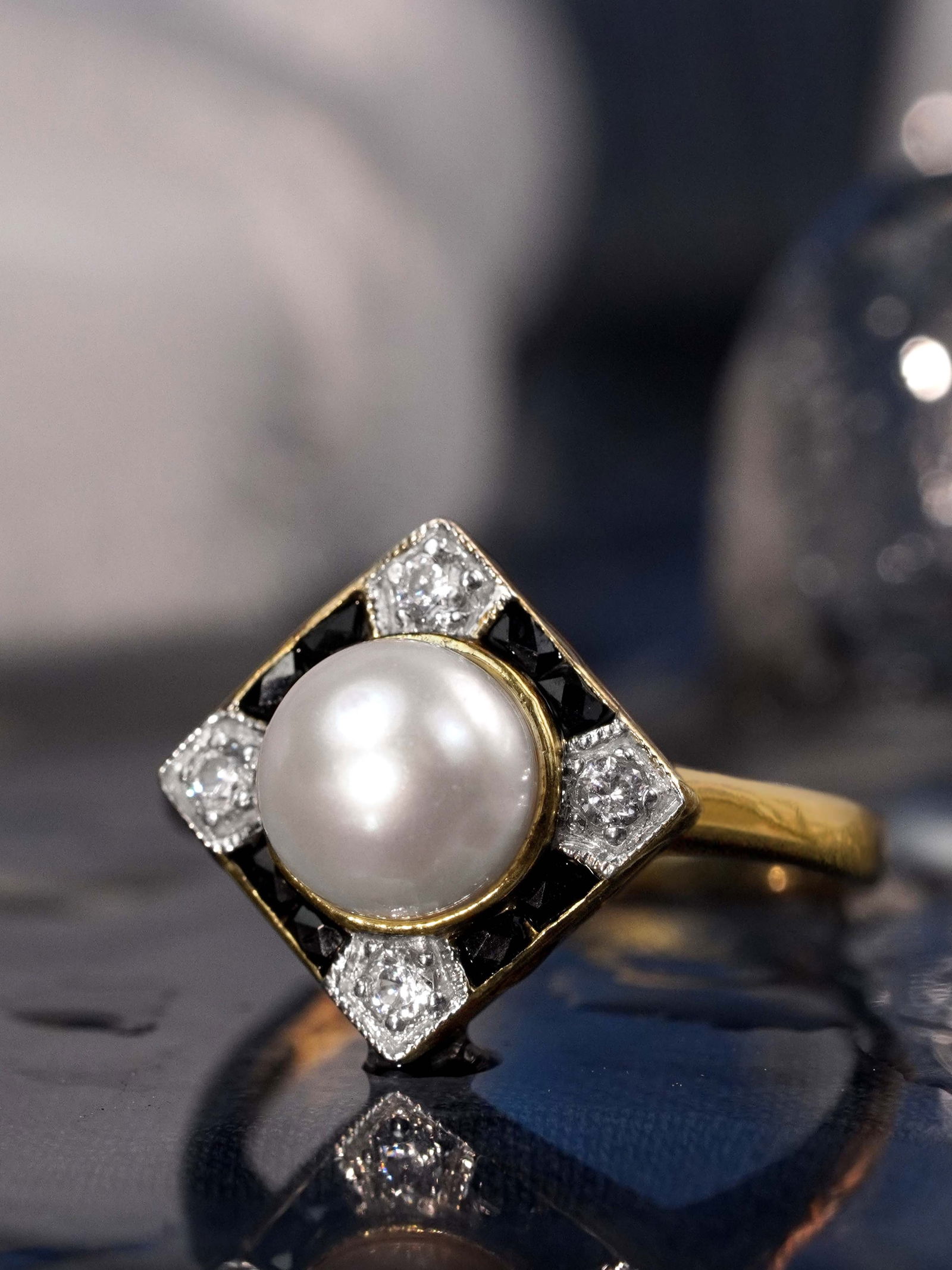 14K Yellow Gold Natural Pearl Onyx and Diamond Art Deco Style Engagement Ring: Ring InformationStyle: Art-decoMetal: 14K Yellow GoldTotal weight: 3.81 g. (approx. total weight)Size: US 7Center Gemstones Type: PearlShape: RoundSize: 7 mm. (look alike)Number: 1Weig