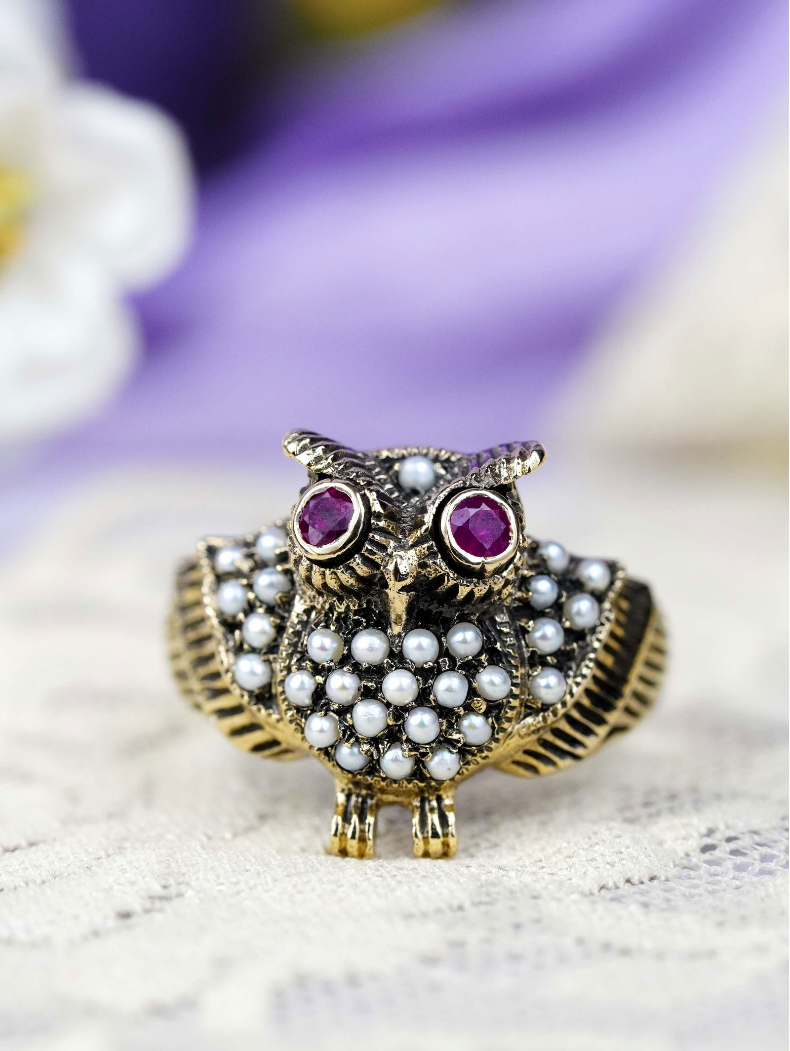 9K Yellow Gold Natural Ruby and Pearl Vintage Style Owl Ring: CHARACTERISTICSOrigin: ThailandMetal: Solid 9K Yellow GoldRing Size: US 7Total Gemstones Weight: 0.65 carat. (approx.)Total Gram Weight: 4.39 g. (approx.)*Pictures have been enlarged to show details*P