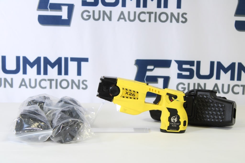 Axon X26 Taser: This unique Axon X26 taser is a great non-lethal option. It comes with 1 battery, 1 cartridge, a holster and cartridge holders. This taser shows normal sign of usage. Please see photos. - Bore: ; Acti