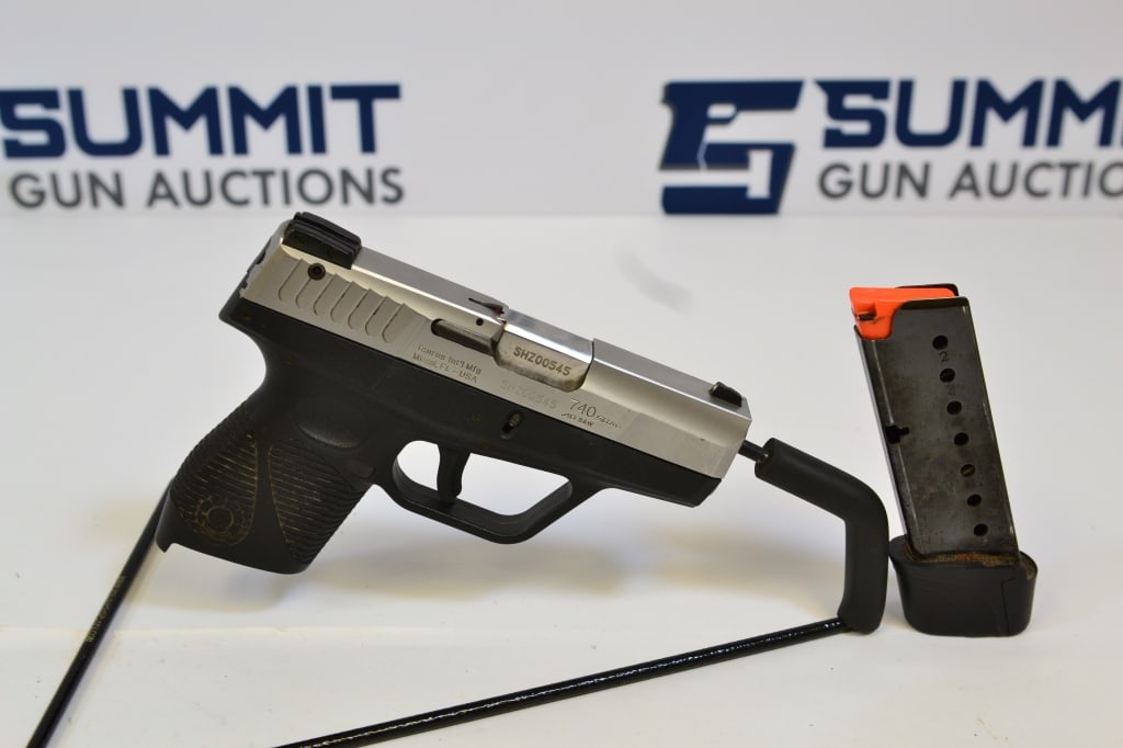 Taurus 740 Slim .40 S&W: Up for auction is a two-toned compact .40 caliber pistol. Comes with fixed front and adjustable rear sights, selector and trigger safeties, extended magazine. Overall in good condition. Please see pho