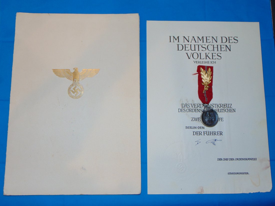 WWII German Award Document 2nd Class Eagle Order w/ Russian Front Medal Pinned Inside, Hitler Signed: NICE AWARD DOCUMENT FOR 2ND CLASS EAGLE ORDER, HAS HITLER AUTO PEN SIGNATURE, DOCUMENT IS BLANK, BUT HAS A RUSSIAN FRONT MEDAL PINNED INSIDE WITH A HIGH RANKING S/A COLLAR TAB DEVICE TO THE RIBBON. EM