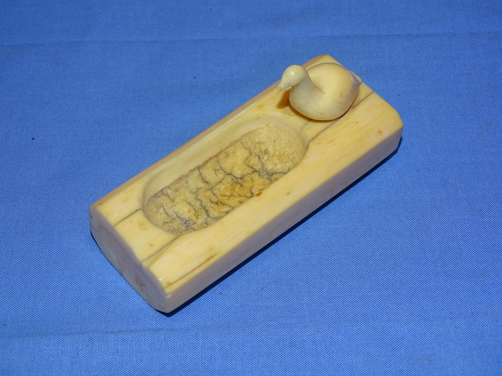 Inuit Carved Walrus Tusk Bird Fetish Statue Ashtray ?: NICE INUIT WALRUS TUSK CARVING OF A BIRD ON WHAT APPEARS TO BE AN ASHTRAY ? IT MEASURES APPROX. 4 1/2" LONG.