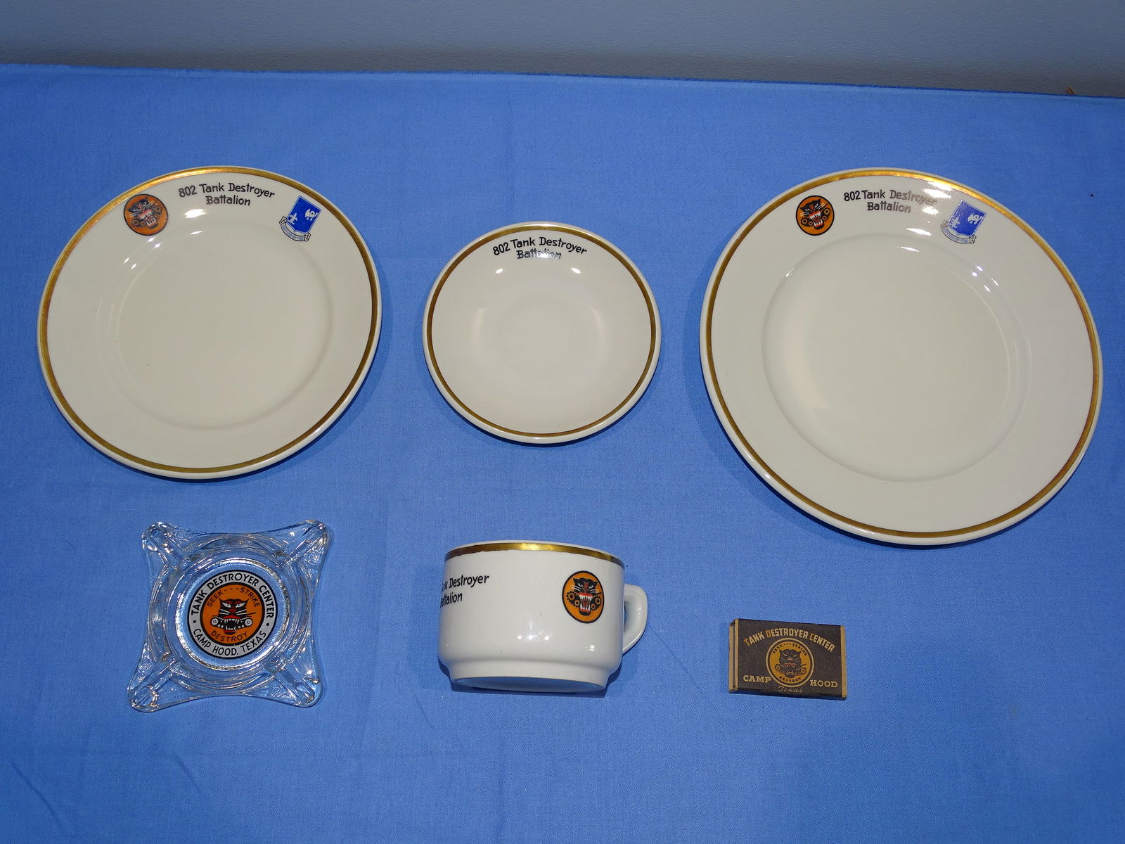 WWII 802nd Tank Destroyer Battalion China Lot, TD Bn: NICE LOT OF WWII TD ITEMS, INCLUDING A DINNER PLATE, SALAD PLATE, CUP AND SAUCER, ALL DECORATED WITH 802nd TD INSIGNIA, A TD ASHTRAY AND MATCH BOX.