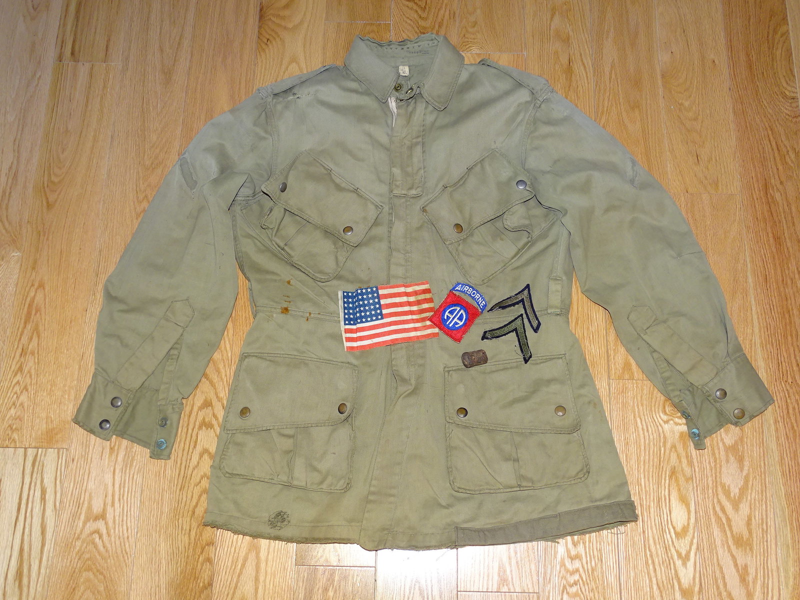 Salty WWII 82nd Airborne Paratrooper Reinforced M42 Jump Jacket: NICE SALTY WWII 82nd AIRBORNE M42 PARATROOPER JUMP JACKET. THIS JACKET HAS GREAT WEAR FROM USE, REPAIRS, HOLES, STAINS, ELBOWS AND LOWER EDGE HAVE BEEN REINFORCED WITH A HEAVIER CANVAS MATERIAL. ZIPPE