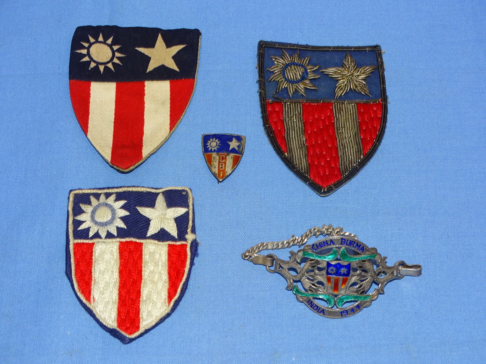 WWII China Burma India CBI Theater Made Patch Trio, Pin & Enamel Bracelet: NICE WWII CBI ITEMS INCLUDING 3 THEATER MADE PATCHES, A THEATER MADE CBI CREST, AND AN ENAMEL BRACELET.