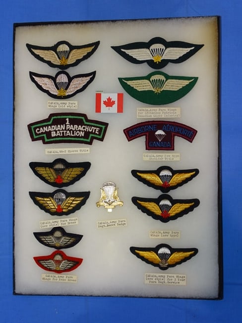 Airborne Paratrooper Wings, Patch Insignia Lot, CANADA: LARGE COLLECTION OF AIRBORNE PARATROOPER INSIGNIA, YOU WILL RECEIVE THE EXACT ITEMS SHOWN IN THE CASE, INCLUDING THE DESCRIPTIONS. THE RIKER MOUNT CASE IS NOT INCLUDED.