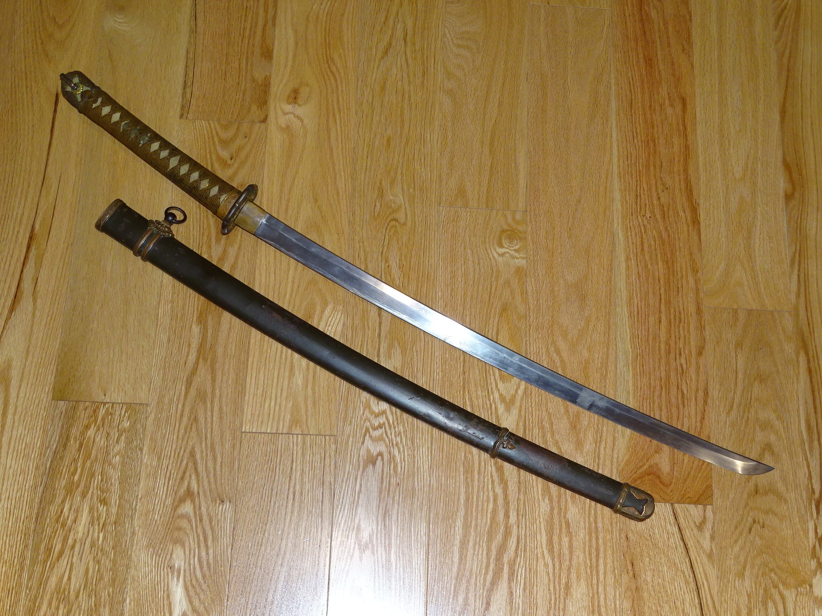 WWII Japanese IJA Army Officer's Shin-Gunto Sword, Signed & Dated: WWII JAPANESE ARMY OFFICER'S SWORD, SHOWS HONEST SIGNS OF USE AND WEAR. IT HAS A 26 1/4" CUTTING EDGE, THE TANG IS SIGNED AND DATED.