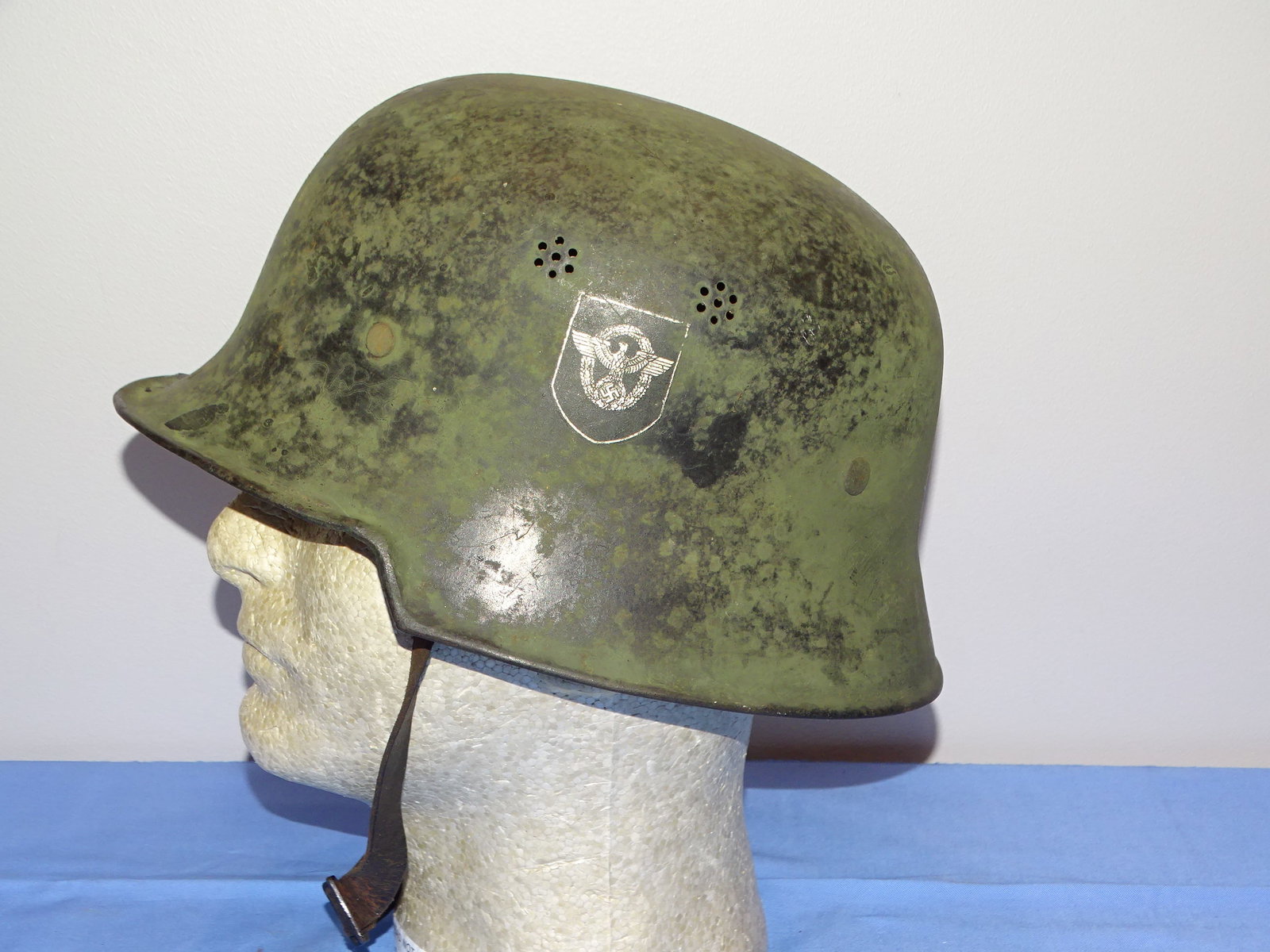 WWII German Nazi M34 Double Decal Police Helmet in Camoflage Paint: NICE CLEAN UNTOUCHED ESTATE FOUND WWII GERMAN M34 DOUBLE DECAL POLICE HELMET IN SUPER RARE CAMO PAINT. LINER AND CHIN STRAP ARE PRESENT AND INTACT. A REAL UNICORN OF A HELMET HERE.