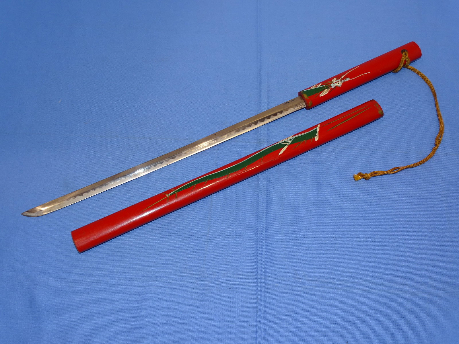 Souvenir Tourist Trade Miniature Japanese Sword 19": SOUVENIR JAPANESE SWORD, WOOD MOUNTED WITH PAINTED DRAGON MOTIF. ACID ETCHED BLADE, BUT SURPRISINGLY SHARP FOR A SOUVENIR. IT MEASURES APPROX. 19" LONG OVERALL.