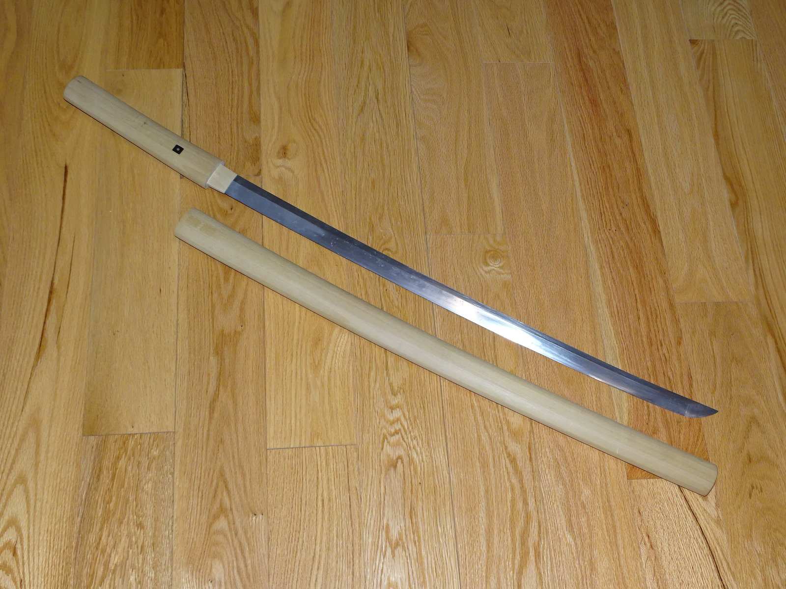 Japanese Samurai Sword, Katana w/ 27 5/8" Cutting Edge: JAPANESE SAMURAI SWORD IN SHIRA SAYA RESTING MOUNTS. THE SWORD IS BEEFY WITH A 27 5/8" CUTTING EDGE. IT IS IN NEED OF POLISH, OR ENJOY / USE AS IS. LOOKS TO HAVE A STRAIGHT TEMPER LINE, NO BAD OR NOTI