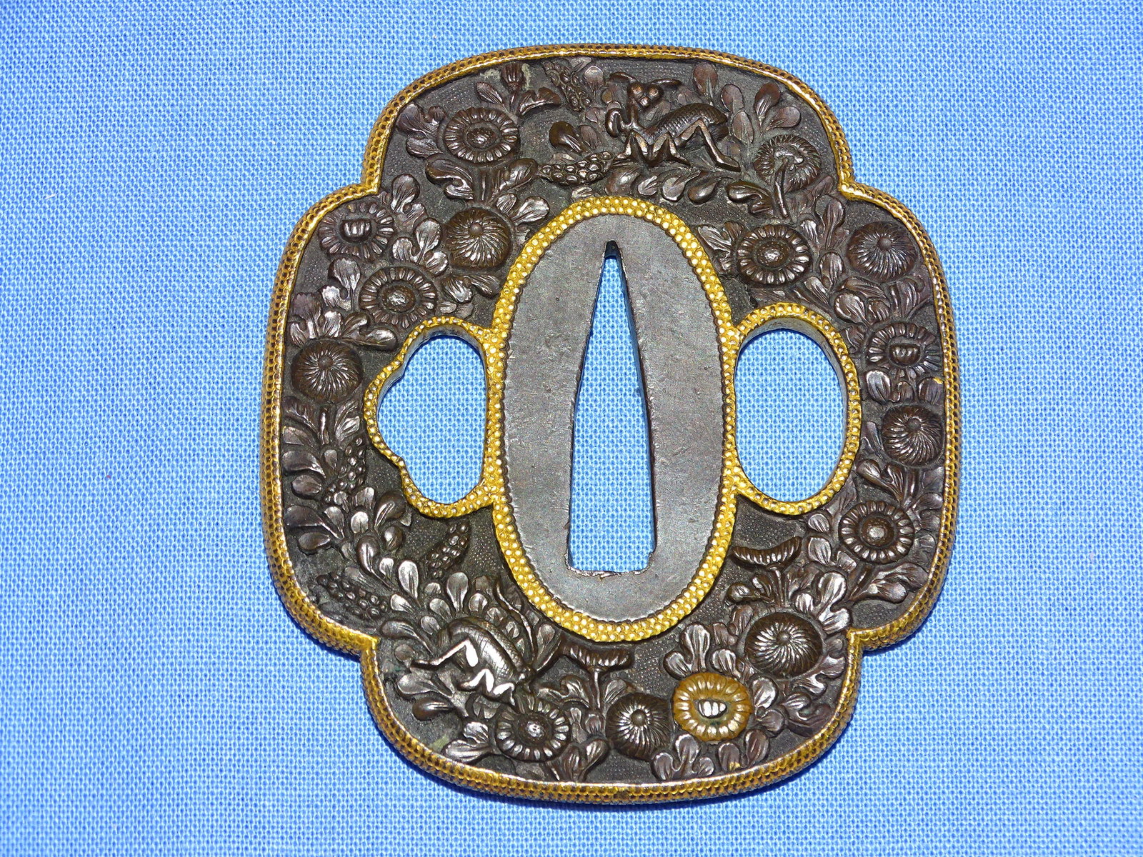 Japanese Samurai Sword Guard TSUBA, Shakudo w/ Insects & Flowers: JAPANESE SAMURAI SWORD TSUBA, SHAKUDO NANAKO WITH OVERALL CHRYSANTHEMUMS AND INSECTS, WITH GOLD HIGHLIGHTS AND RIM.