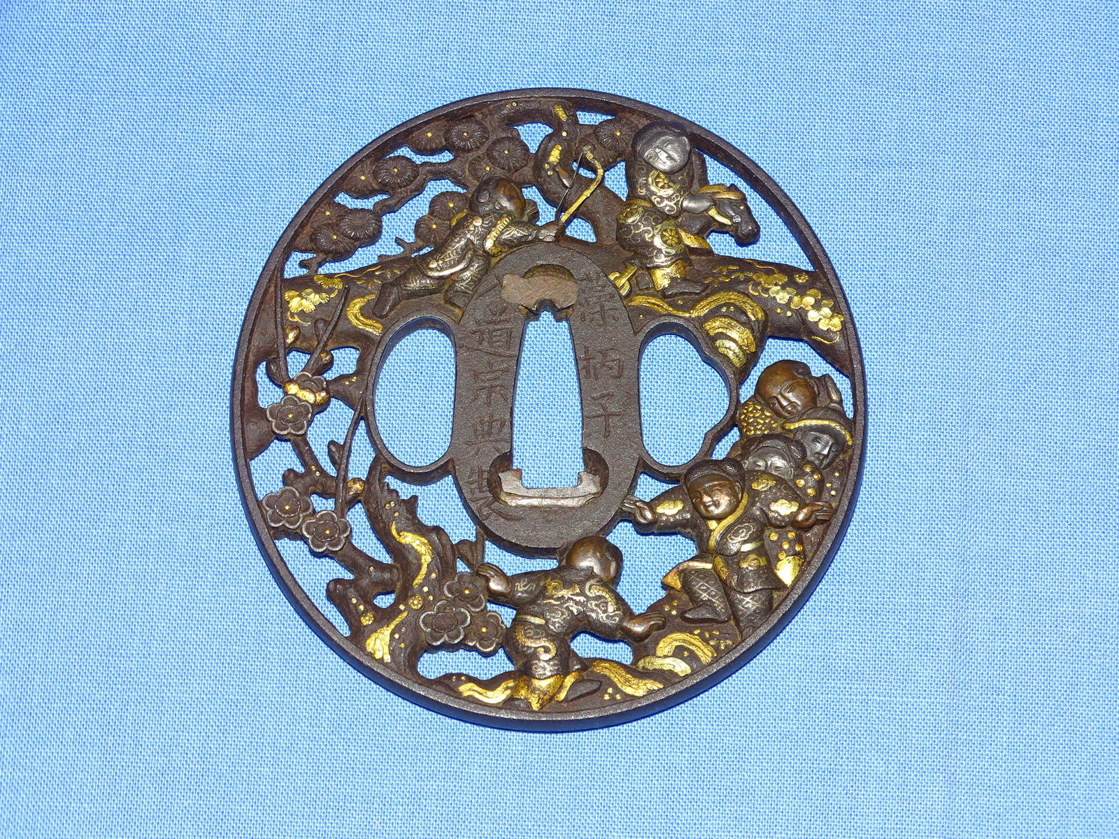 Japanese Samurai Sword Guard TSUBA, Pierced Iron w/ Mixed Metal & Signed: JAPANESE SAMURAI SWORD TSUBA, IRON WITH WARRIORS IN MIXED METALWORK.