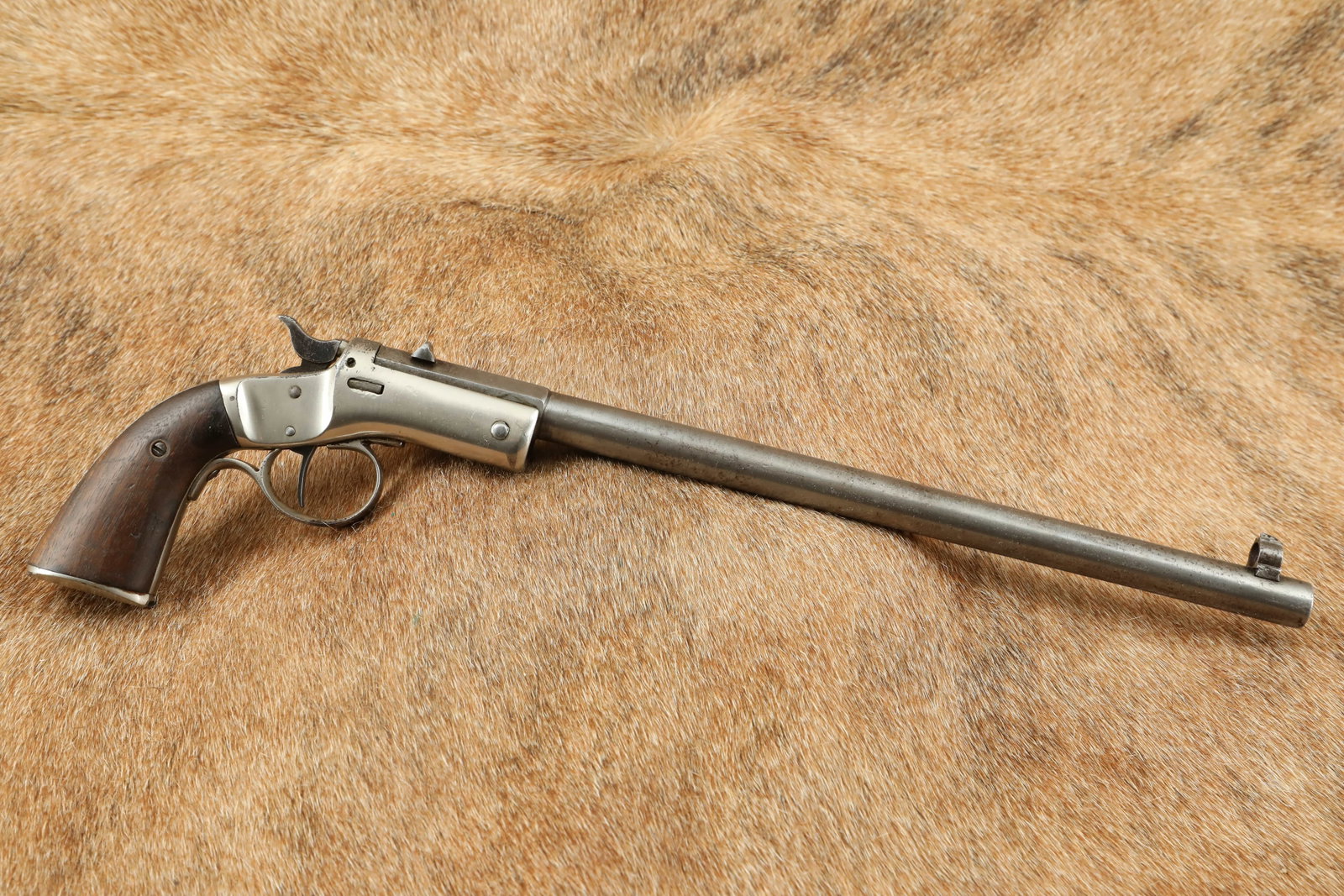 Stevens New Model Pocket Rifle No. 40 .22 12” Tip-Up Single Shot Pistol ca. 1896-1916 C&R: Make: J. Stevens Model: 32 Serial Number: 26409 Year of Manufacture: 1890s Antique Caliber: 22 Action Type: Single shot Markings: Top flat of the octagon /round heavy barrel shows “J. STEVENS A &T C