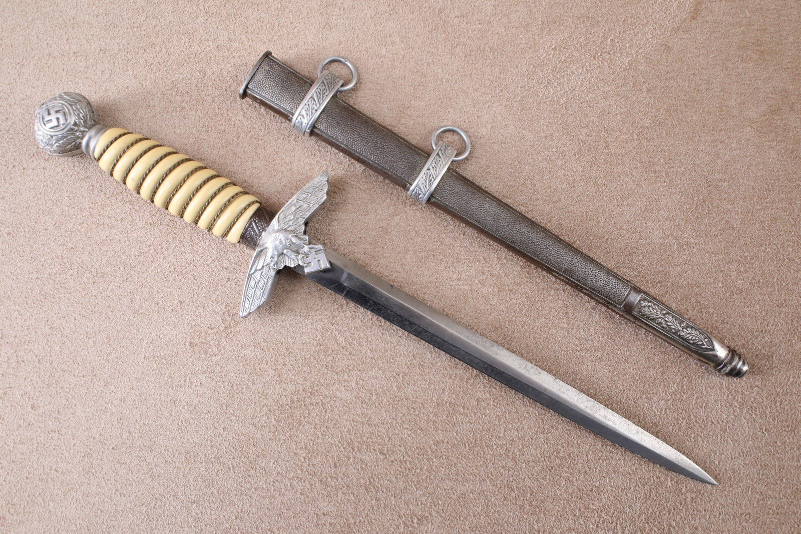 German WW2 Luftwaffe Officer E.F. Horster 2nd Model Dress Dagger, Sheath: Good Condition. Some sharpening to the blade edges. A small chip in the middle blade edge. Moderate cleaning, scratching, and pitting to the blade. Some ligh