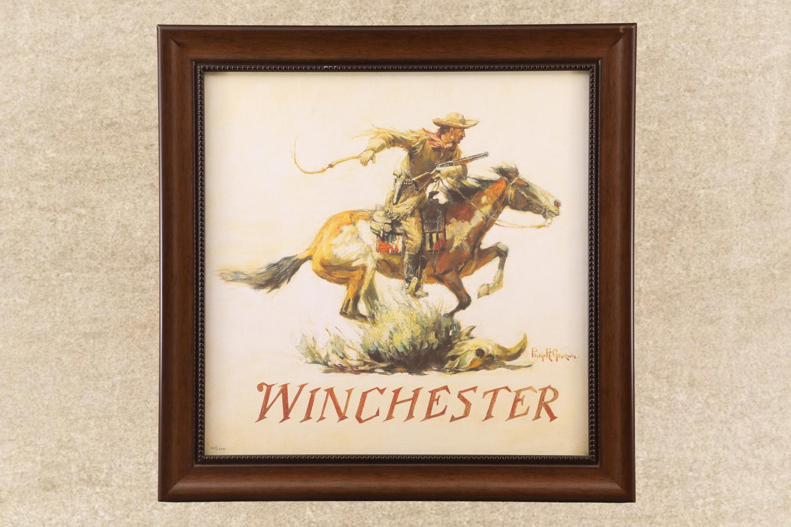 Limited Edition 163 Of 2500 Philip R Goodwin Winchester Horse And Rider Framed Print, 24x24": Winchester Horse And Rider framed print by Philip R Goodwin. Showcases a cowboy on horseback leaping over a bison skull, rifle in hand. The dynamic pose captures the thrilling life on the American wes
