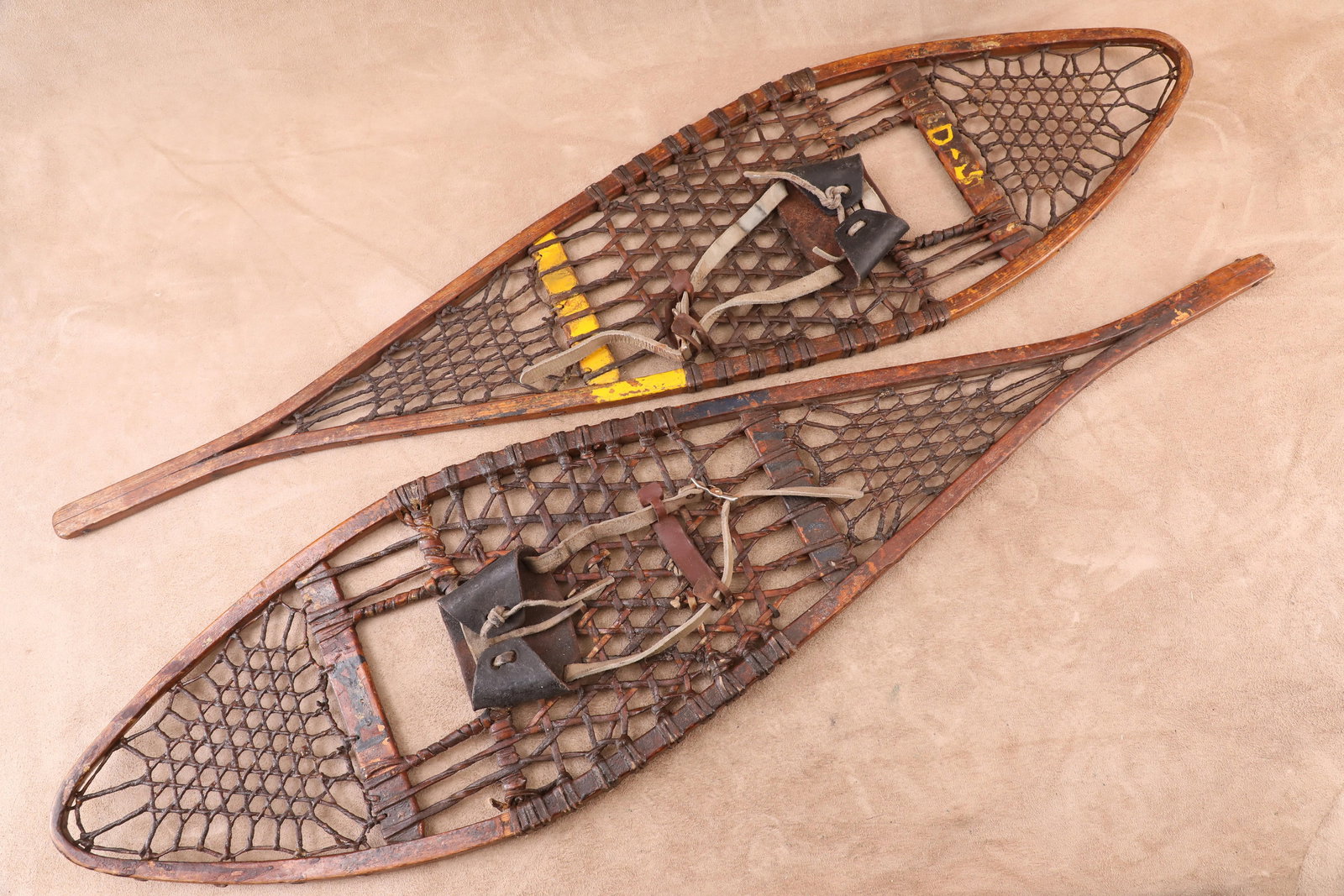 Vintage 1940s US Forest Service "USFS" Marked 12.5" x 48" Snowshoes: Good Condition. The left snowshoe has a faded maker's decal at middle that remains illegible. The left and right snowshoes are marked "D-4" in blue paint and "D-5" in yellow paint at middle, respectiv