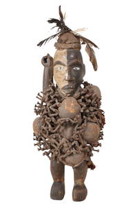 Fetish Figure DR Congo: This mid to late 20th-century, 19" carved wood fetish figure is from the Kongo people in the Democratic Republic of the Congo. The torso is embedded with fetish bundles and impaled with nails.