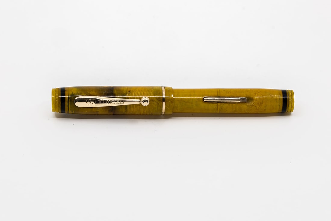 Gold Bond Stonite Transparent Celluloid Fountain Pen: Gold Bond Stonite transparent celluloid fountain pen. This yellow toned transparent Gold Bond Stonite pen has clean gold filled trim and marked Gold Bond Guaranteed for Life 14K fine flexible nib. Len
