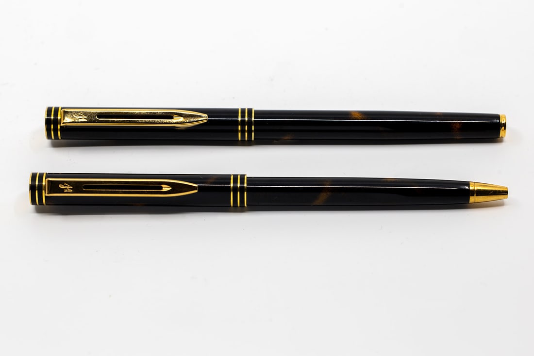 Waterman Exclusive Tiger Eye Fountain Pen Set: Waterman Exclusive Tiger Eye fountain pen and ballpoint set. Bright Tiger Eye lacquer finish with gold trim, extra fine Waterman Ideal 18K 750 Paris nib, without converter. Length 5 9/16” (both)