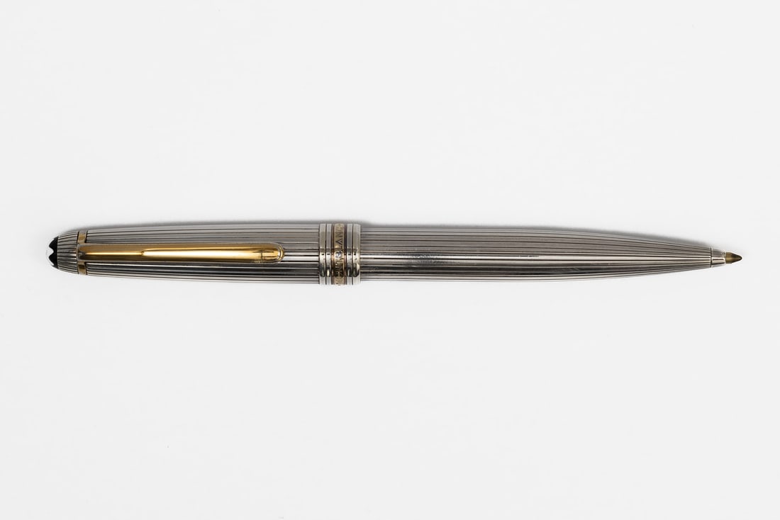 Montblanc Sterling Silver Solitaire Pinstripe Ballpoint Pen: Montblanc sterling silver solitaire pinstripe ballpoint pen. Marked 925 on cap and Germany on clip, classic Montblanc design with gold trim and cap band, cartouche engraved. Length 5 3/8”. Overa