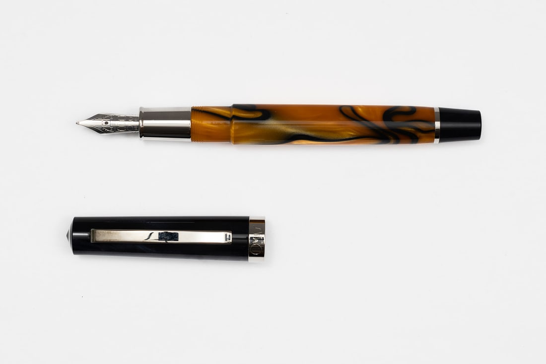 Omas Bologna Orange & Blue Fountain Pen: Omas Bologna Orange & Blue fountain pen with box, outer box, case and papers. Omas Bologna in blue/grey smoke colour with orange barrel with blue swirls and 14K fine nib. Length 5 3/8” and 6 3/8