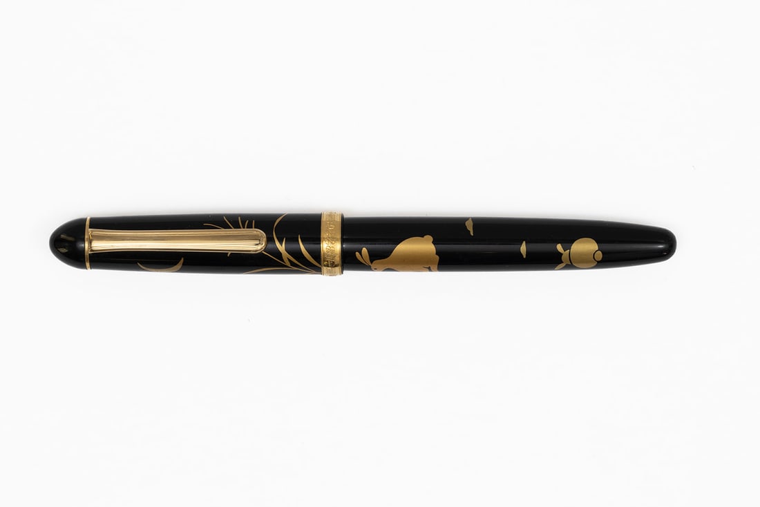 Platinum Century 3776 Maki-e Rabbit & Moon Fountain Pen: Platinum Century 3775 maki-e rabbit and crescent moon fountain pen. Maki-e style Platinum Century 3776 press fit cap with rabbits, clouds, plant life and crescent moon as well as signature in gold, Pl