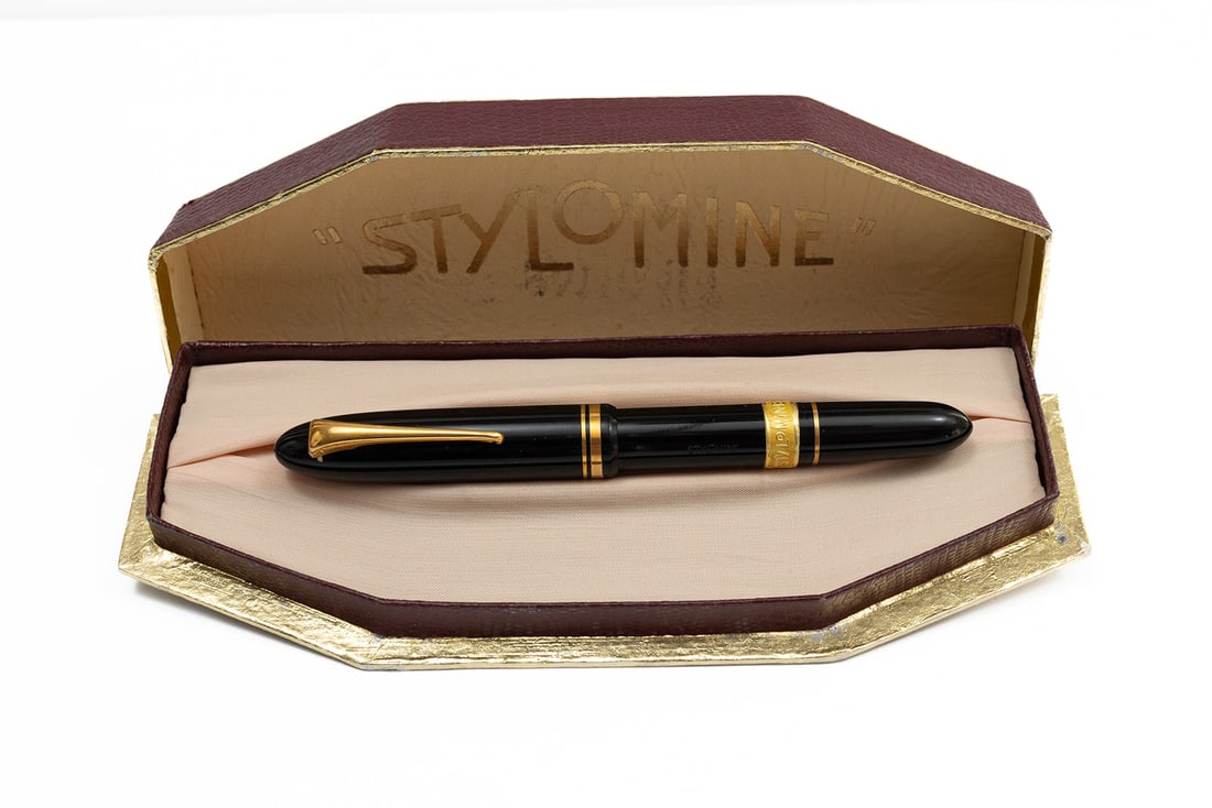 Stylomine 303 Fountain Pen, New Old Stock: Stylomine 303 new old stock fountain pen, boxed. Stylomine 303 with original foil band on barrel and rocker clip. Intact accordion sac with lower glass cartridge and extra fine Stylomine 303 18K flexi