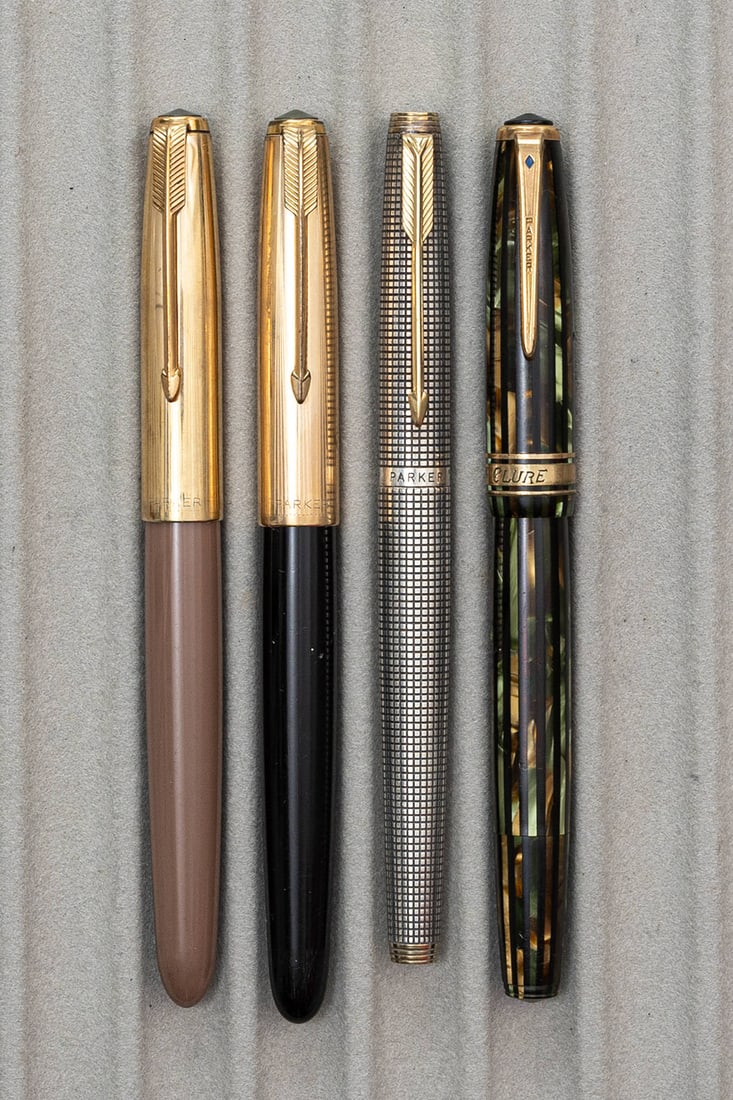 Parker Duofold, 51 & 75 Fountain Pen Lot (4): Parker Duofold, 51 and 75 fountain pen lot (4). Parker Duofold Laidtone in Emerald stripe with deluxe triple band (engraved) and broad Parker Duofold 14K nib (missing band at base of barrel), Parker 5