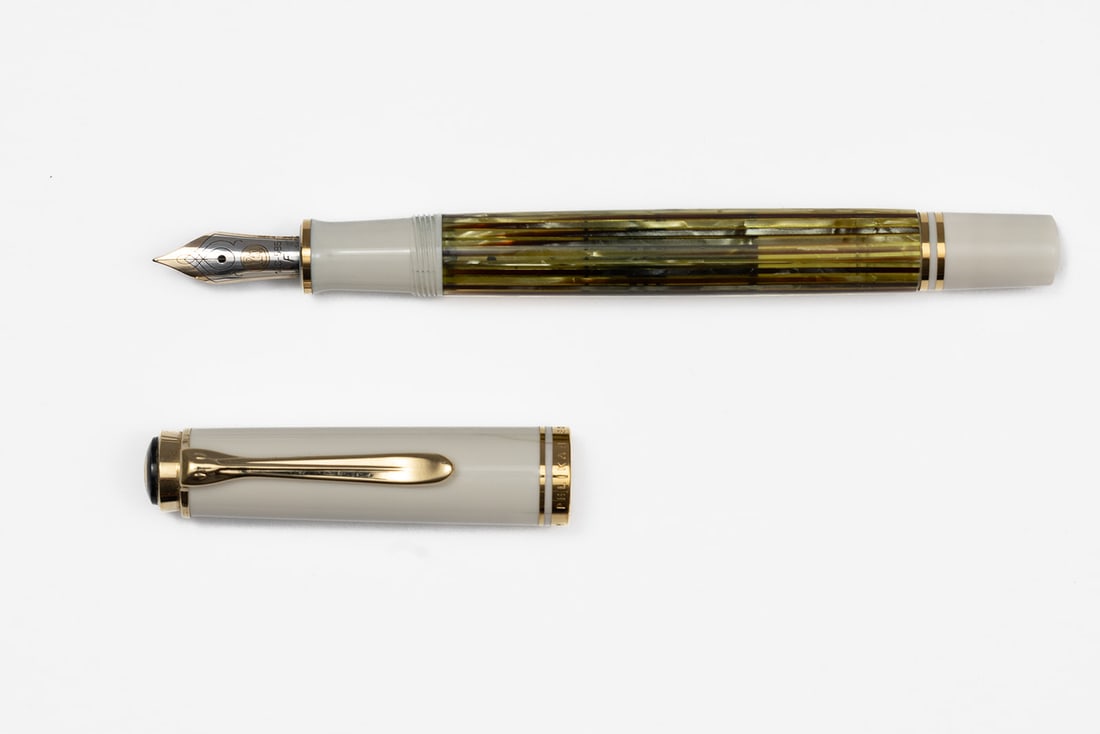 Pelikan M400 White Tortoise Fountain Pen, Flawed: Pelikan M400 White Tortoise fountain pen with box and papers. Classic Pelikan M-series design with white cap and end combined with Tortoise striated barrel and two-tone 14K fine nib. Length 4 3/4&rdqu