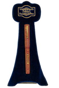 Waterman Ideal Rose Ripple 94 Fountain Pen Store Display: Waterman Ideal 94 Rose Ripple store display pen. Likely for a shop window or on top of a store display case, Waterman 94 in Rose Ripple with blue velvet Waterman display and gold Waterman graphics, le