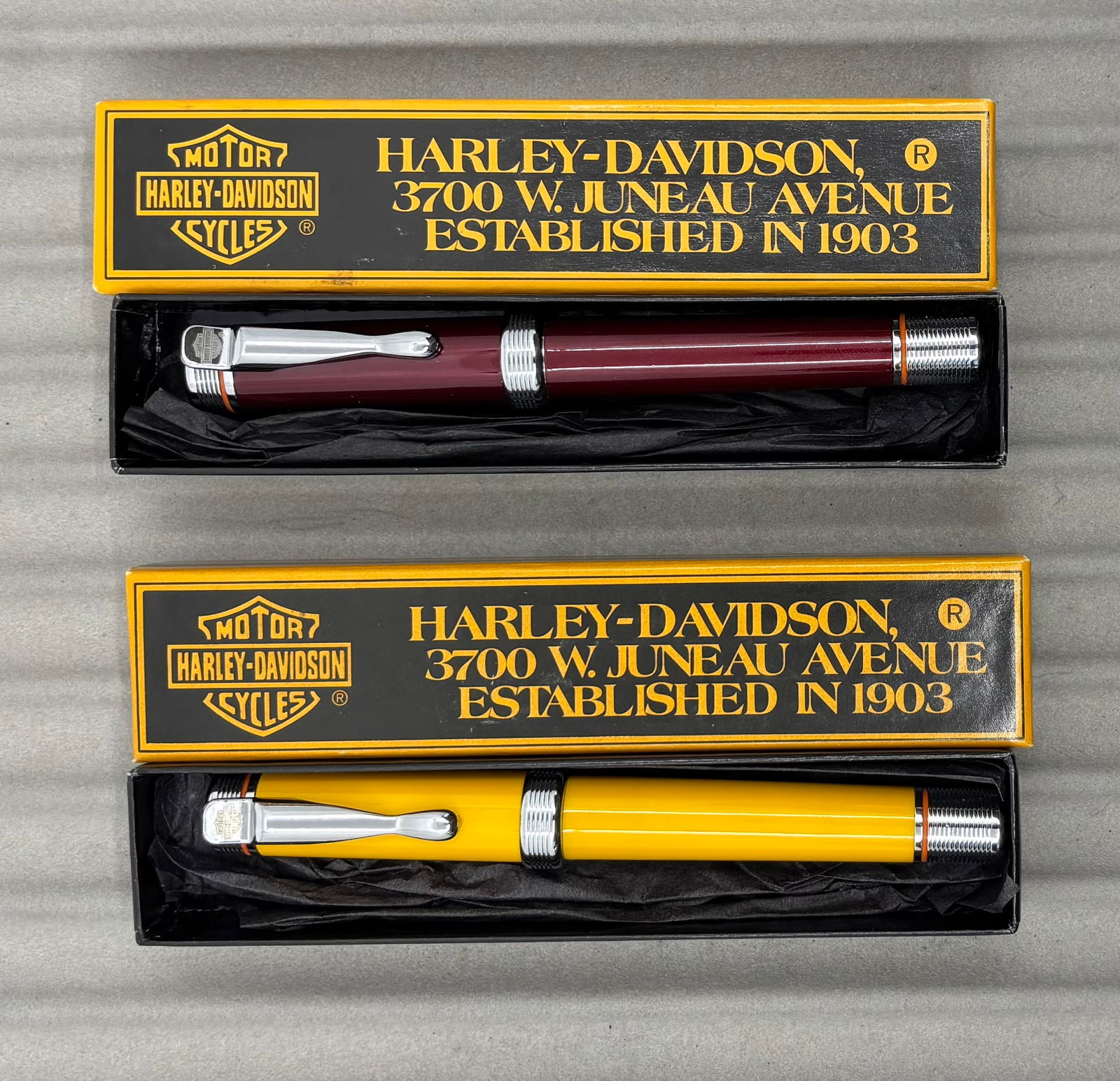 Waterman Harley Davidson Fountain Pens, Boxed (2): Waterman Harley Davidson fountain pens, boxed (2). Red with medium nib in box along with yellow with medium nib in box. Overall excellent condition.
