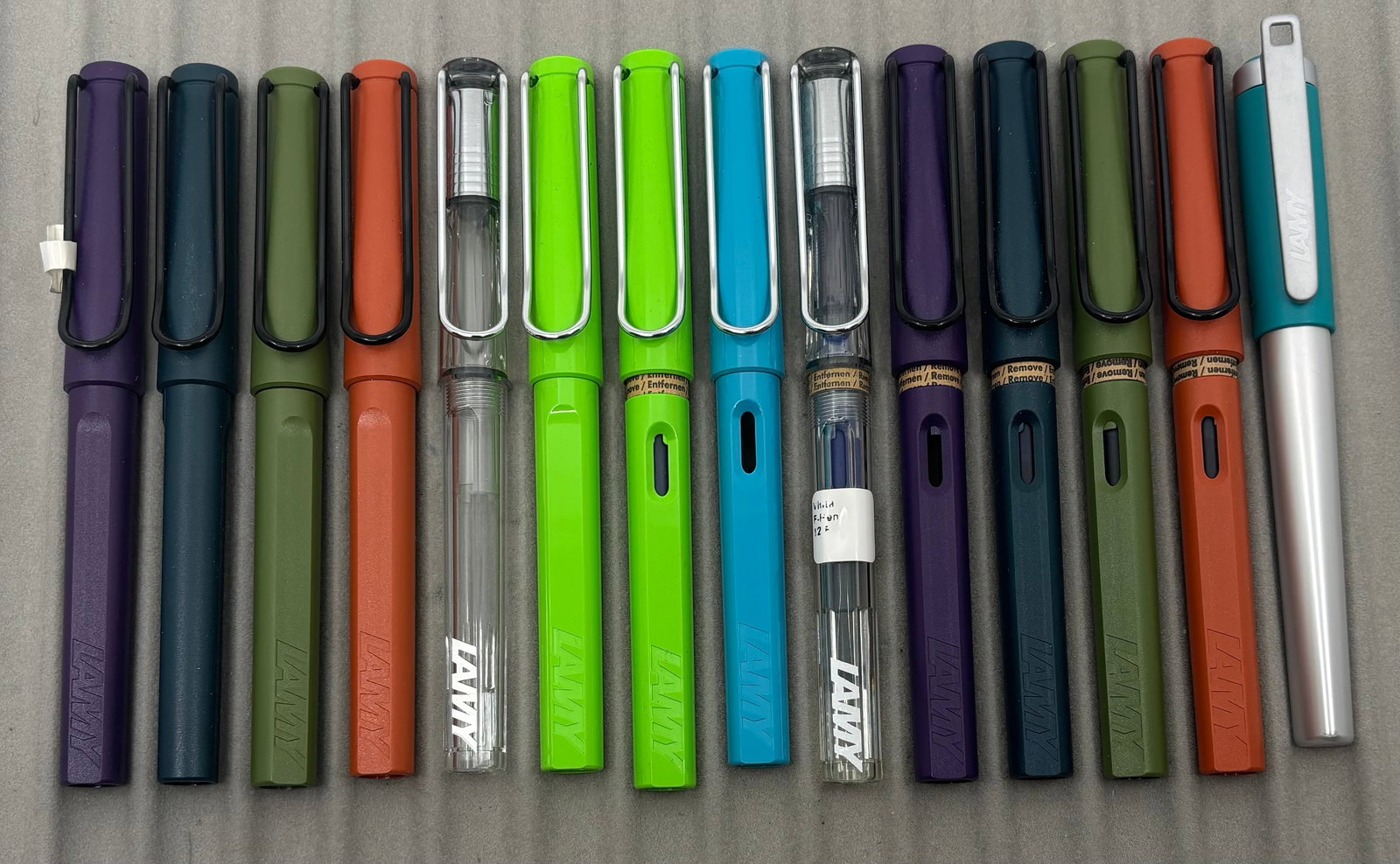 Lamy Safari & Other Fountain Pen & Rollerball Lot (14): Lamy Safari and other fountain pens and rollerballs, boxed. Assorted colours of fountain pens and rollerballs. Overall good condition.