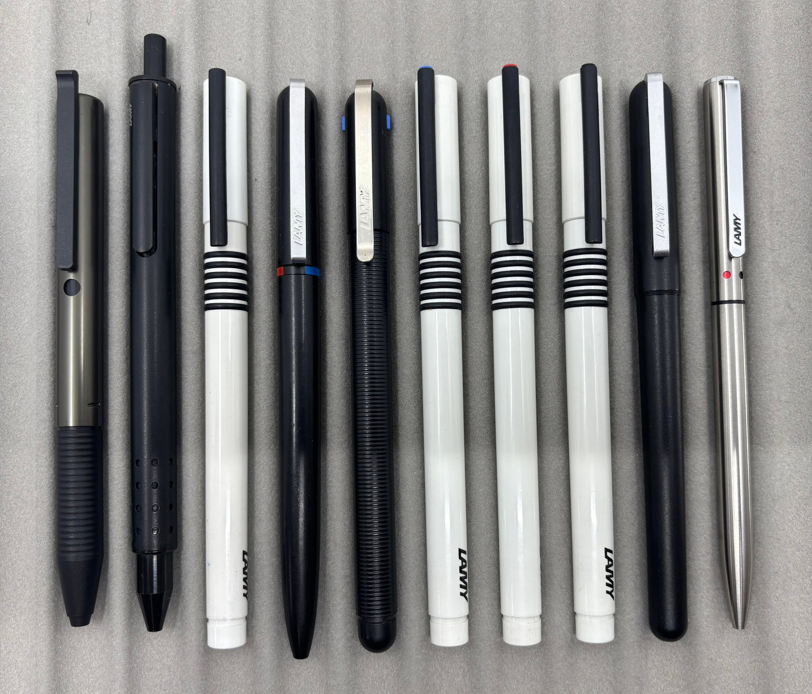 Lamy Pen & Pencil West Germany Lot (9), Boxed: Assorted Lamy pens and pencils made in West Germany. Ballpoint pens, ink writers and pen/pencils in boxes or pouches. Overall mixed condition.