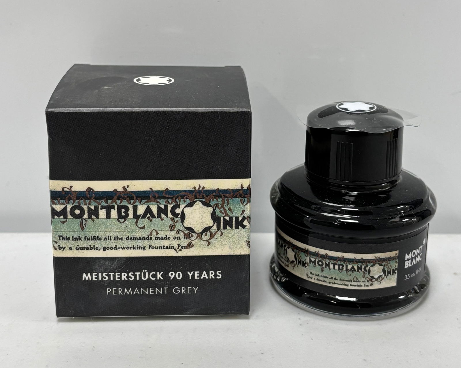 Montblanc Meisterstuck 90 Years Permanent Grey Fountain Pen Ink Bottle: Montblanc 90 Years limited edition navy blue fountain pen ink. Montblanc produced this ink when they released the 90th anniversary fountain pen series. Overall excellent condition, ink used sparingly