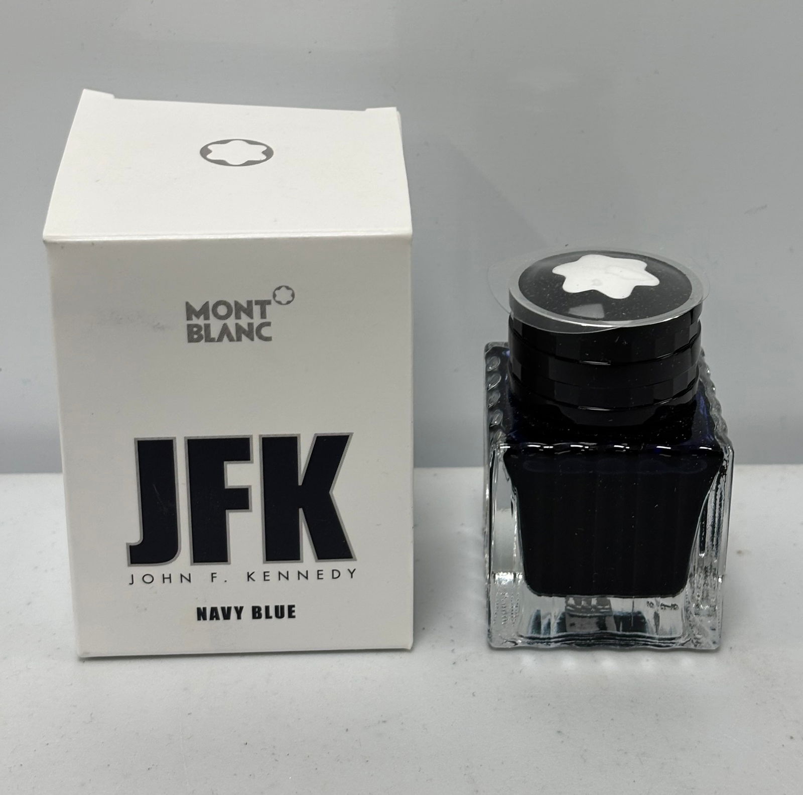 Montblanc JFK Limited Edition Navy Blue Fountain Pen Ink Bottle: Montblanc JFK limited edition navy blue fountain pen ink. Montblanc produced this ink when they released the JFK fountain pen series. Overall excellent condition, ink used sparingly if at all.