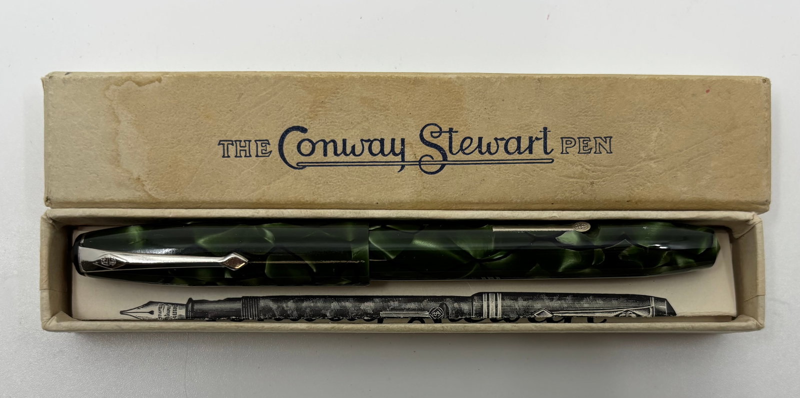Conway Stewart 15 Green Marble Fountain Pen, Boxed: Conway Stewart 15 green marble fountain pen with box and papers. Model 15, bandless with nickel trim and 1A fine 14K Conway Stewart nib. Length 5” and 6 1/8” posted, filling mechanism