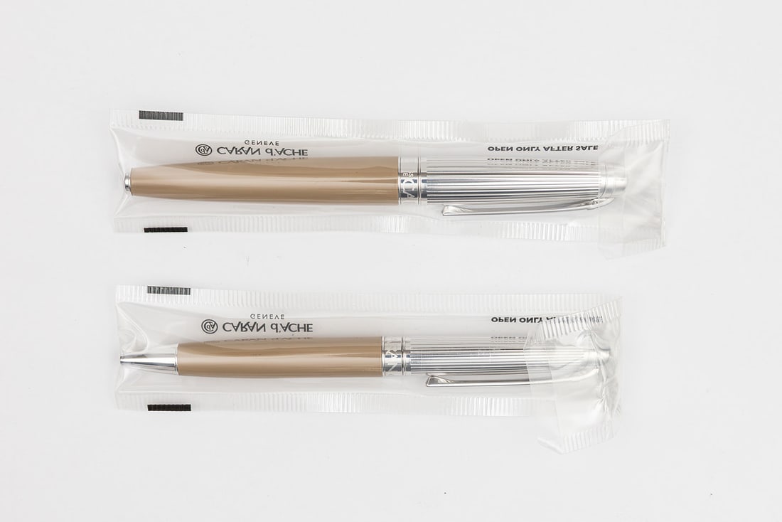 Caran d’Ache Leman Bi-Colour Cashmere Rollerball & Ballpoint Pen Set SEALED: Caran d’Ache Leman Bi-Colour Cashmere rollerball and ballpoint pen set with boxes, papers and outer sleeves. Both pieces are sealed in cellophane and are new old stock. Cashmere beige colour set off