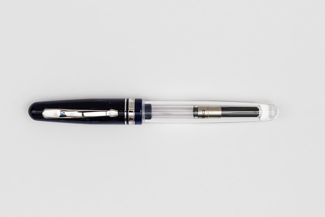 Delta Fusion 82 Blue Marble Demonstrator Fountain Pen/Rollerball Pen: Delta Fusion 82 fountain pen/rollerball convertible limited edition pen. Delta Fusion 82 in blue marble with demonstrator body, comes with rollerball end and fountain pen section with 18K two-tone stu