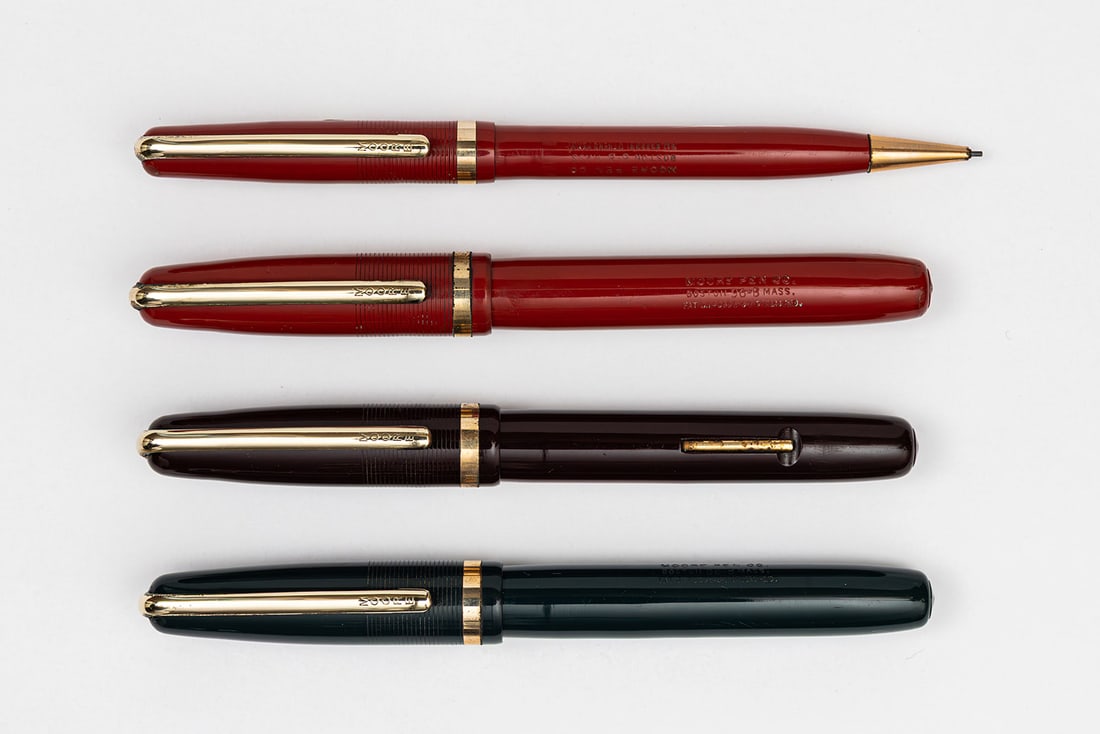Moore Fingertip Fountain Pen & Pencil Collection (4): Moore Fingertip 96-B fountain pen collection (4), circa 1946-1950. The Fingertip pen has a unique metal section and nib assembly with 14K nib that runs down the center. The Moore 96-B version is the l